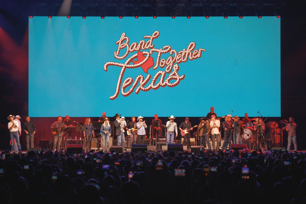 The full lineup of Texas talent joins together on-stage at the Moody Center in Austin, Texas on Aug. 17, 2025, for a triumphant final sing along of “On The Road Again.” | Photo Credit: Jeff Johnson