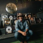 Zach Top, flanked by RIAA Platinum and Gold records. Photo Credit: Hunter Hart |